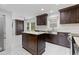 The kitchen features dark cabinetry, stainless steel appliances, and a large island with marble countertop at 3996 Spalding Ln, Atlanta, GA 30350