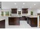 Modern kitchen featuring dark wood cabinets, granite countertops, and stainless steel appliances at 3996 Spalding Ln, Atlanta, GA 30350