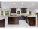 Modern kitchen featuring dark cabinetry, stainless steel appliances, and a center island at 3996 Spalding Ln, Atlanta, GA 30350