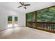 The sunroom features tiled floors, white walls, a ceiling fan, and double glass doors leading to the deck at 3996 Spalding Ln, Atlanta, GA 30350