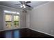 Bright bedroom with hardwood floors, ceiling fan, and double doors to a private balcony at 4244 River Green Nw Dr # 111, Atlanta, GA 30327