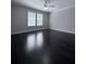 Bright bedroom featuring two windows and a modern ceiling fan at 4244 River Green Nw Dr # 111, Atlanta, GA 30327