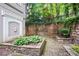 Enclosed courtyard with lush plantings and a brick paver patio at 4244 River Green Nw Dr # 111, Atlanta, GA 30327