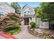 Clubhouse exterior shows meticulous landscaping, stone pathway, and inviting double-door entrance at 4244 River Green Nw Dr # 111, Atlanta, GA 30327