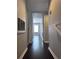 Long hallway featuring hardwood floors and neutral walls, leading to a bedroom at 4244 River Green Nw Dr # 111, Atlanta, GA 30327