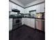 Modern kitchen featuring white cabinets, stainless steel appliances, and dark countertops at 4244 River Green Nw Dr # 111, Atlanta, GA 30327