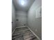 Dedicated laundry room with vinyl flooring, storage shelf, and utility connections at 4244 River Green Nw Dr # 111, Atlanta, GA 30327