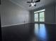 Inviting living room featuring hardwood floors, high ceilings, and balcony access at 4244 River Green Nw Dr # 111, Atlanta, GA 30327
