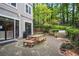 Community patio area complete with picnic table, stone grill, and lush foliage at 4244 River Green Nw Dr # 111, Atlanta, GA 30327