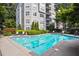 Community pool features clear water, lounge chairs, and surrounding greenery for relaxing at 4244 River Green Nw Dr # 111, Atlanta, GA 30327