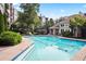 Community pool featuring clear water, lounge chairs, and lush landscaping in a serene setting at 4244 River Green Nw Dr # 111, Atlanta, GA 30327