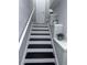 Freshly painted stairway with white trim and black stairs, leading to a landing at 4244 River Green Nw Dr # 111, Atlanta, GA 30327