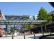 Town center featuring outdoor dining and shopping, all designed with a modern architectural style at 4244 River Green Nw Dr # 111, Atlanta, GA 30327