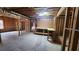 Unfinished basement featuring workbench area, exposed insulation, and framing at 488 Morris Rd, Hiram, GA 30141