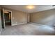 Expansive bedroom with neutral walls and carpet, featuring multiple entryways at 488 Morris Rd, Hiram, GA 30141