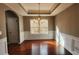 A well lit formal dining room featuring chair rail detail and laminate flooring at 488 Morris Rd, Hiram, GA 30141