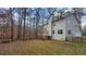 Exterior view of the home showcasing the deck and wooded backyard and vinyl siding at 488 Morris Rd, Hiram, GA 30141