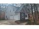 Two-story home with a two-car garage, stone accents, and mature trees at 488 Morris Rd, Hiram, GA 30141
