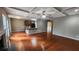 Open-concept living room featuring hardwood floors, fireplace, coffered ceiling, and kitchen at 488 Morris Rd, Hiram, GA 30141