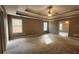 Large main bedroom featuring tray ceilings and a ceiling fan fixture at 488 Morris Rd, Hiram, GA 30141