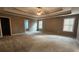 Spacious main bedroom with tray ceiling and a ceiling fan for added comfort at 488 Morris Rd, Hiram, GA 30141