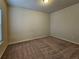 A standard bedroom with neutral colored walls and carpet and a window at 1749 Charcoal Ives Rd, Lawrenceville, GA 30045