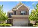 Charming two-story brick home with an attached two-car garage, brown shutters, and a well-manicured front yard at 1749 Charcoal Ives Rd, Lawrenceville, GA 30045