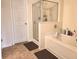 Bright bathroom featuring a tiled floor, shower stall, and a relaxing soaking tub at 3893 Dandridge Way, Duluth, GA 30096