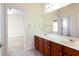 Bathroom featuring double sinks and doorway to bedroom at 2322 Norbury Se Cv, Smyrna, GA 30080