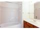 Bathroom featuring tiled walls, a bathtub, and a vanity with a sink at 2322 Norbury Se Cv, Smyrna, GA 30080