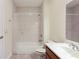 Well-lit bathroom features a tiled shower-over-tub with a white vanity and light tile flooring at 2322 Norbury Se Cv, Smyrna, GA 30080