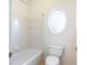 Cozy bathroom with oval window, combined tub and shower at 2322 Norbury Se Cv, Smyrna, GA 30080