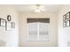 Bright bedroom with white walls, a ceiling fan, and windows dressed with neutral window coverings at 2322 Norbury Se Cv, Smyrna, GA 30080