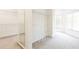 Large walk-in closet with neutral carpet, shelves and a mirror at 2322 Norbury Se Cv, Smyrna, GA 30080