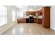 Kitchen featuring tile floor, wood cabinets, granite countertops, and black appliances at 2322 Norbury Se Cv, Smyrna, GA 30080
