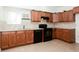 Kitchen featuring dark appliances, granite countertops, tile flooring and wood cabinets at 2322 Norbury Se Cv, Smyrna, GA 30080