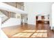 Open-concept living area with hardwood floors, staircase, and views into the kitchen and foyer at 2322 Norbury Se Cv, Smyrna, GA 30080