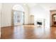 Spacious living room with hardwood floors, fireplace, and large arched window at 2322 Norbury Se Cv, Smyrna, GA 30080