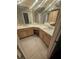 Bathroom with double sinks, granite counters, and wood cabinets offers ample space at 3777 Peachtree Ne Rd # 1324, Brookhaven, GA 30319