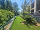 Fully fenced artificial turf dog run with seating, providing a dedicated space for pets to exercise at 3777 Peachtree Ne Rd # 1324, Brookhaven, GA 30319
