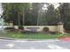 Beautiful community entrance with signage and lush landscaping at 3777 Peachtree Ne Rd # 1324, Brookhaven, GA 30319
