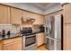 Modern kitchen with stainless steel appliances, granite countertops, and well-lit cabinetry at 3777 Peachtree Ne Rd # 1324, Brookhaven, GA 30319