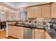 Kitchen with stainless steel dishwasher and sink, granite countertops, and well-lit cabinetry at 3777 Peachtree Ne Rd # 1324, Brookhaven, GA 30319