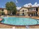 Beautiful pool surrounded by lush landscaping and a well-maintained apartment complex on a bright, sunny day at 3777 Peachtree Ne Rd # 1324, Brookhaven, GA 30319