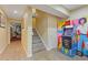 Finished basement area features luxury vinyl flooring, stairs, and an arcade game at 3739 Newhalem Sw St, Atlanta, GA 30331