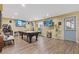 This finished basement area features recessed lighting, a pool table, and a walkout to the yard at 3739 Newhalem Sw St, Atlanta, GA 30331