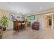 Basement wet bar area features a custom bar, barstools, recessed lights, and a leather armchair at 3739 Newhalem Sw St, Atlanta, GA 30331