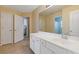 Bright bathroom features a white vanity with double sinks, a large mirror and tile floors at 3739 Newhalem Sw St, Atlanta, GA 30331