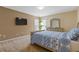 Cozy bedroom features a bed with a patterned blue comforter and a mounted television at 3739 Newhalem Sw St, Atlanta, GA 30331