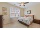 Well-lit bedroom featuring neutral decor, plush carpet, and a ceiling fan at 3739 Newhalem Sw St, Atlanta, GA 30331